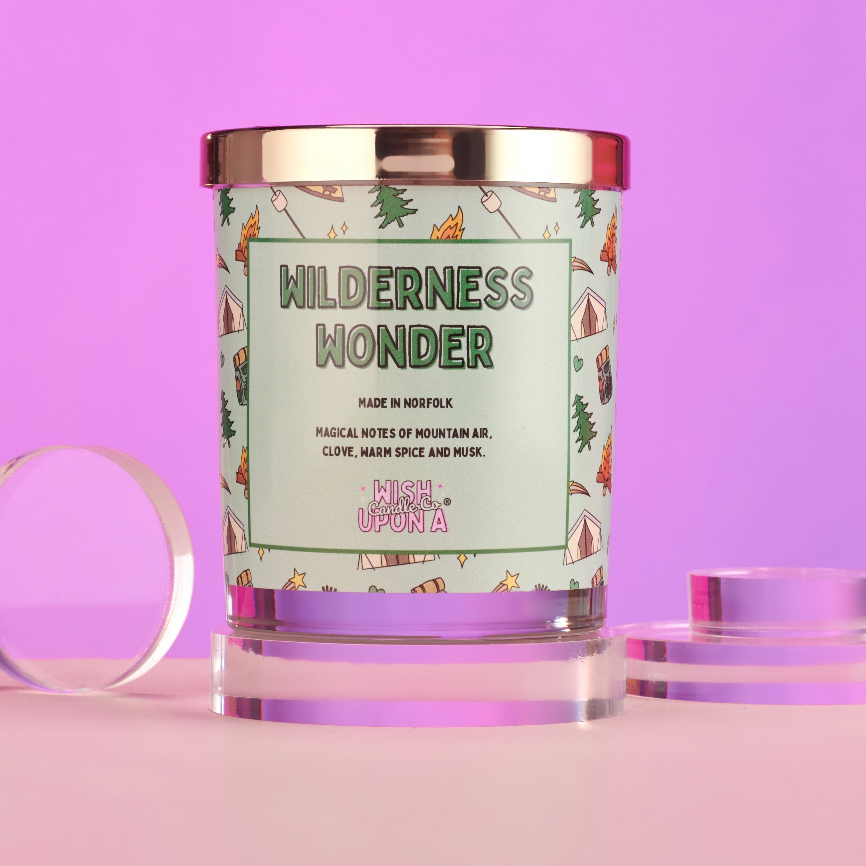 Candle with 'Wilderness Wonder' label on a pink background