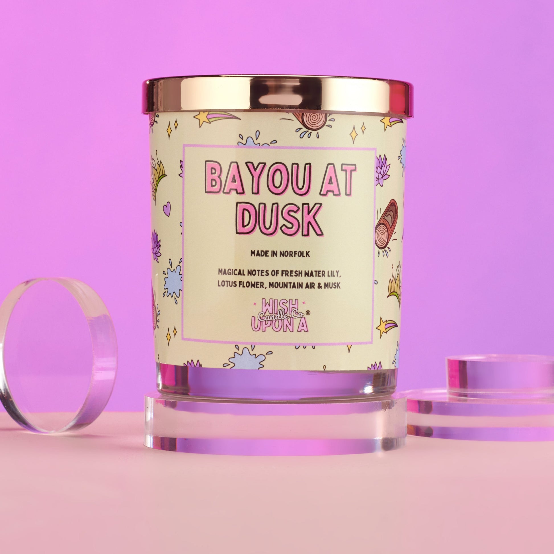 Candle with 'Bayou at Dusk' label on a pink background
