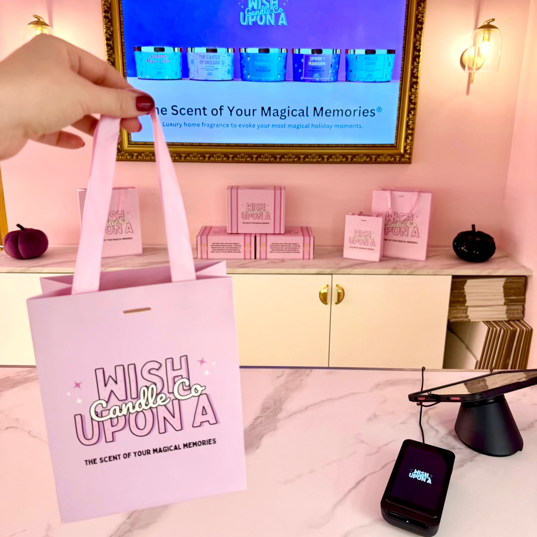 Wish Upon A Candle Co shop counter with branded luxury gift bag and home fragrance products